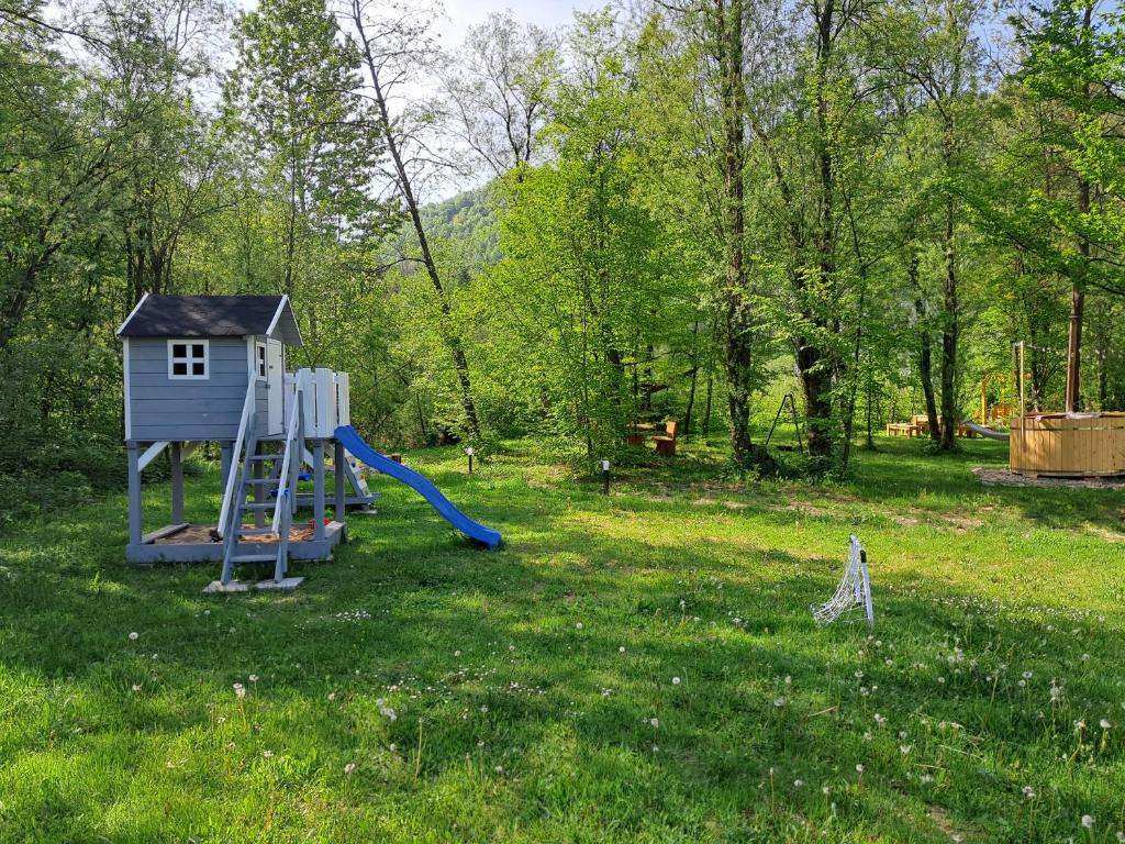 a playground in a field with a slide at Mała Gorczańska Chatka in Ochotnica Dolna