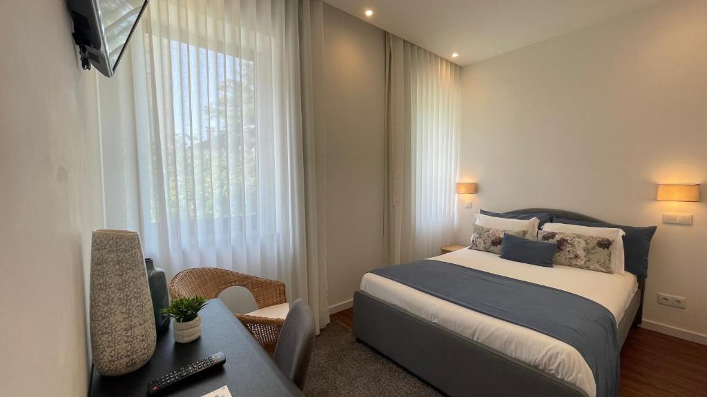 a hotel room with a bed and a window at MyTrip Porto in Matosinhos