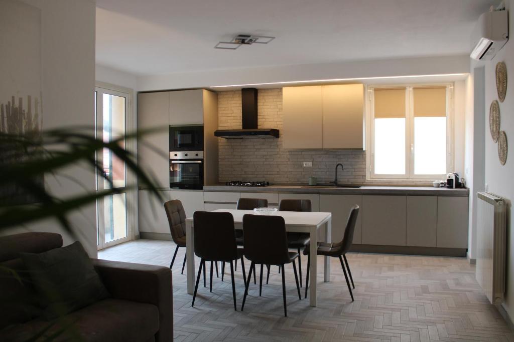 a kitchen and dining room with a table and chairs at GF Holiday Suite 3 in Varazze