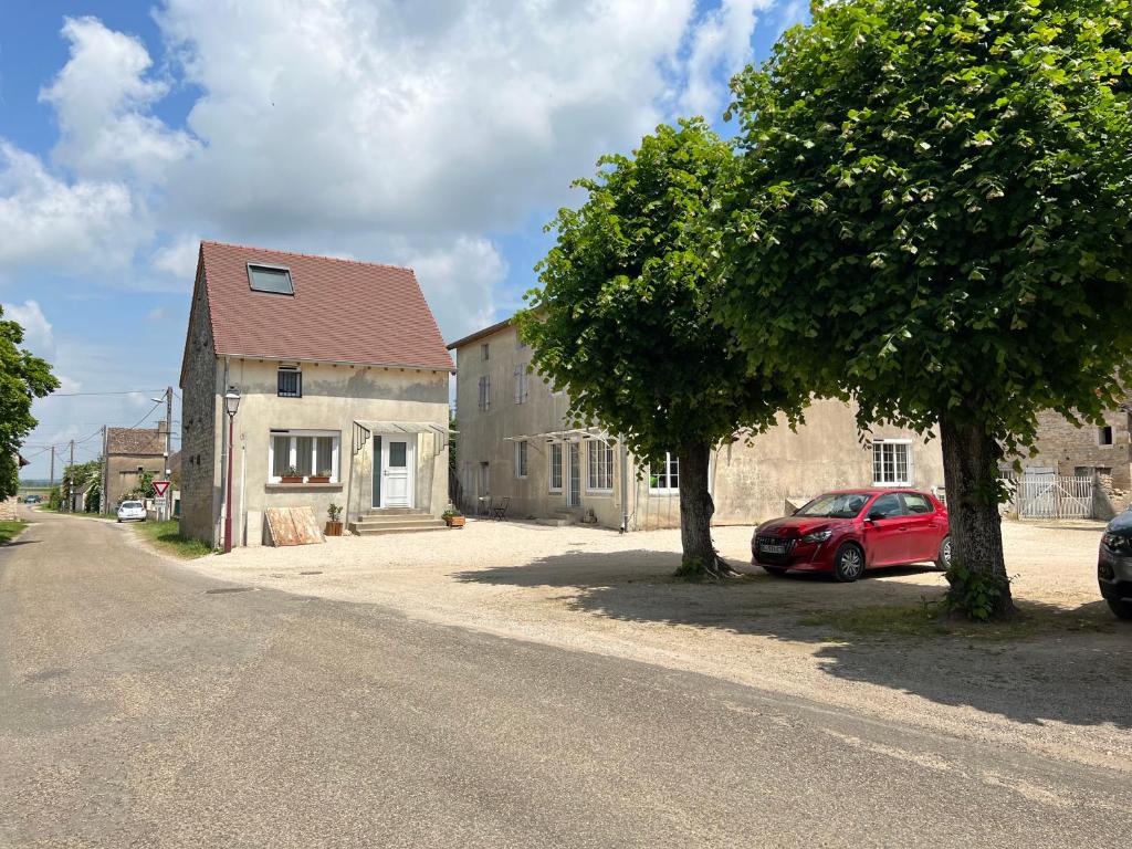 a red car parked in front of a house at Gîtes de la Chapelle in Gigny-sur-Saône
