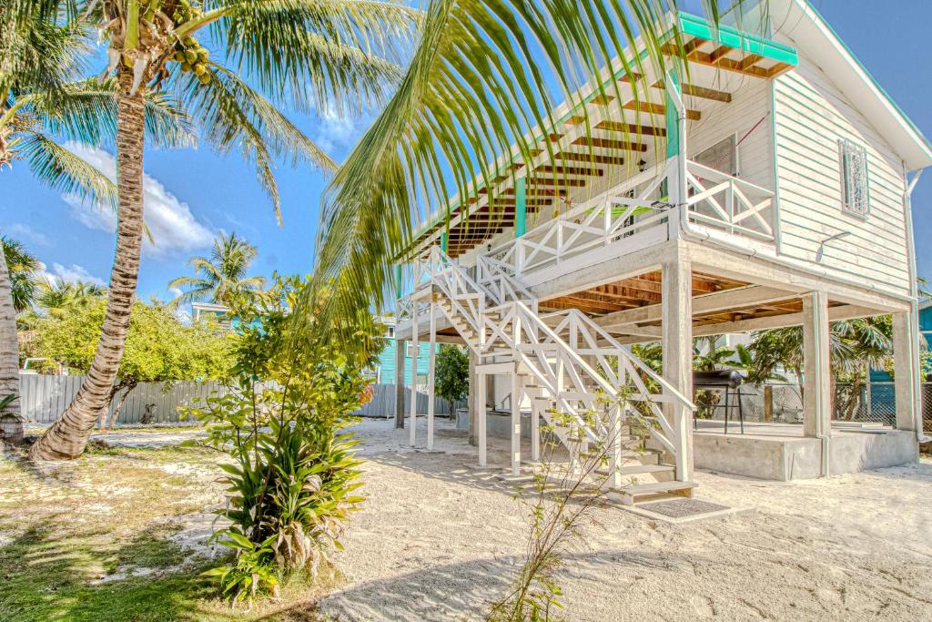 a house with a staircase on the side of it at DV 4 at DV Cabanas Gold Standard Certified in Caye Caulker