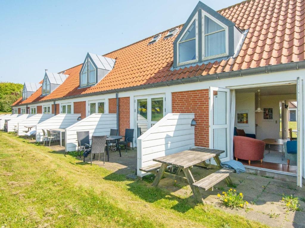 a row of houses with chairs and a picnic table at 6 person holiday home in Lemvig in Lemvig
