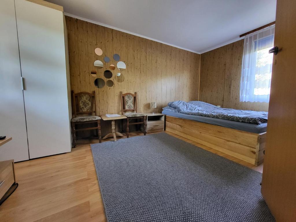 a bedroom with a bed and a desk in it at Agroturystyka Pod Lipą in Małe Leżno