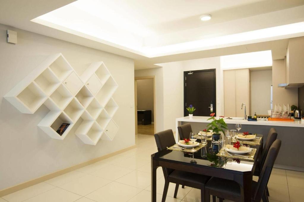 a dining room with a black table and chairs at 3Bed Apart in the Heart of KL in Kuala Lumpur