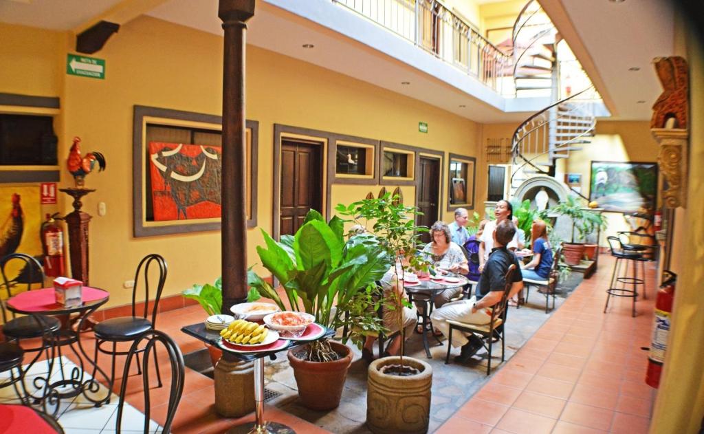 un grupo de personas sentadas en mesas en un restaurante en Hotel Los Balcones de Chinandega, en Chinandega