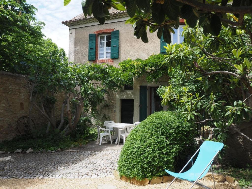 una casa con una mesa y sillas frente a ella en Nice provençal holiday home with garden and pool, Mollans-sur-Ouvèze, en Mollans-sur-Ouvèze