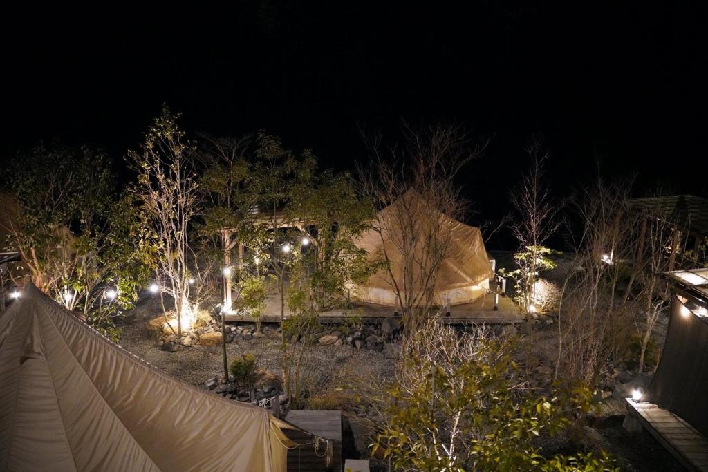 a backyard at night with a tent and lights at STELLA SPORTS - Vacation STAY 43152v in Nishimera