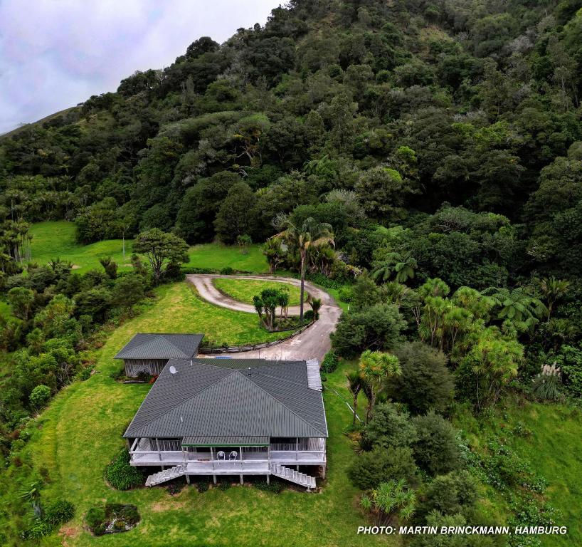 an aerial view of a house in the middle of a mountain at Waiotemarama Falls Lodge in Opononi