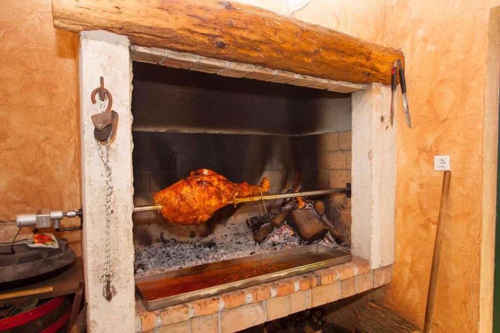 un morceau de viande préparé dans un four en briques dans l'établissement Holiday Homes in Porec - Istrien 42537, à Poreč