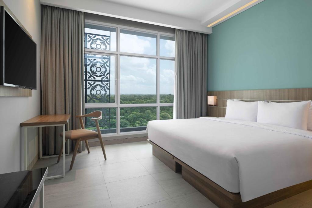 Postel nebo postele na pokoji v ubytování Hotel Santika Gunungkidul