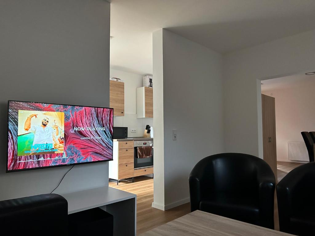 TV i/ili multimedijalni sistem u objektu Moderne Service Apartment / Ferienwohnung