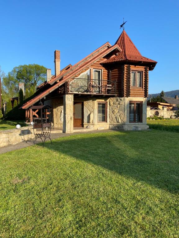 a house with a large yard in front of it at Sofiya in Mykulychyn