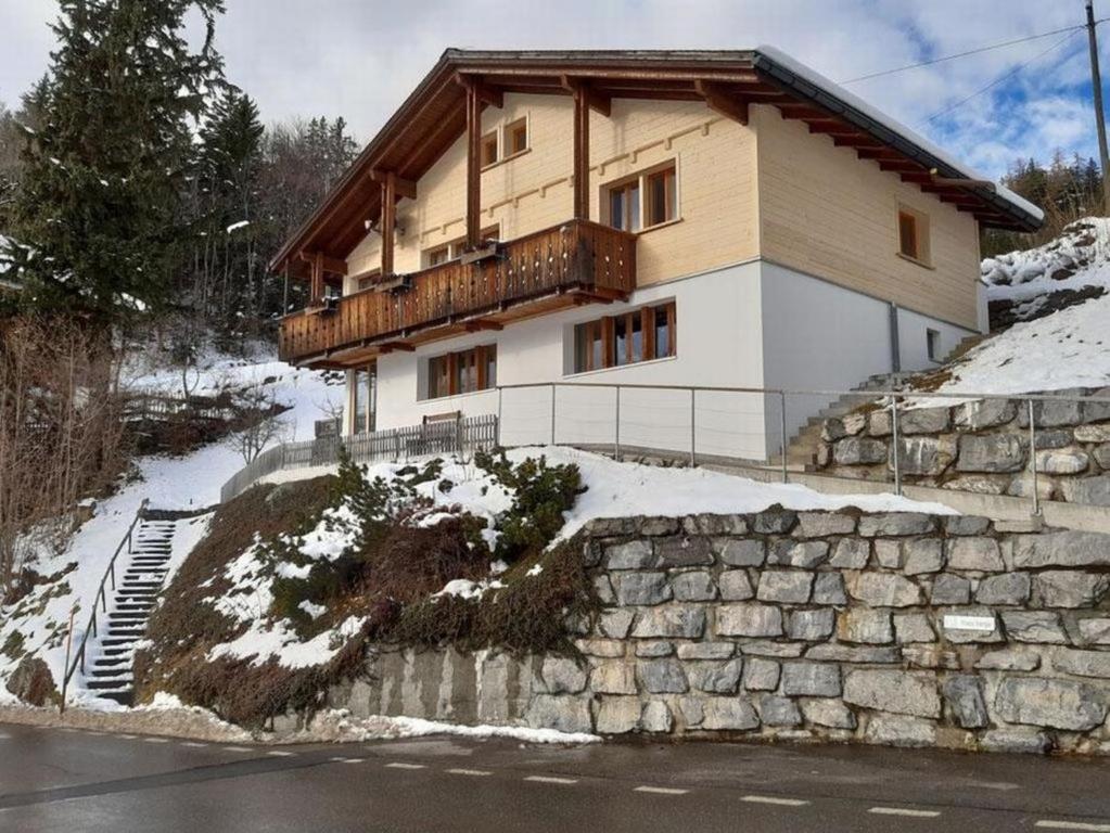a house on the side of a hill with snow at Chalet Varga in Hasliberg