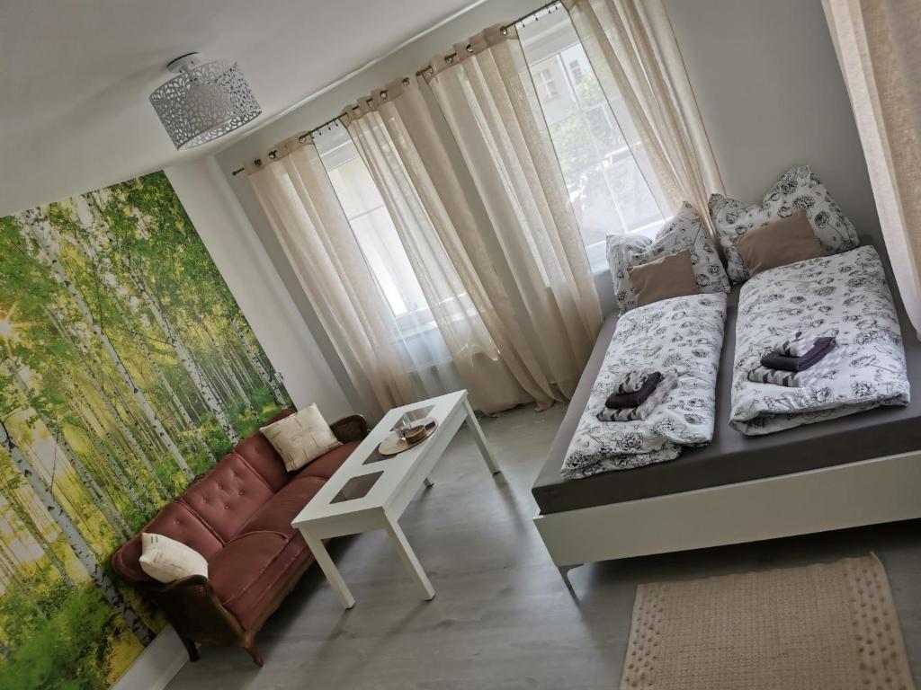um quarto com uma cama, um sofá e uma janela em Prywatne mieszkanie w sercu Cieplic em Jelenia Góra