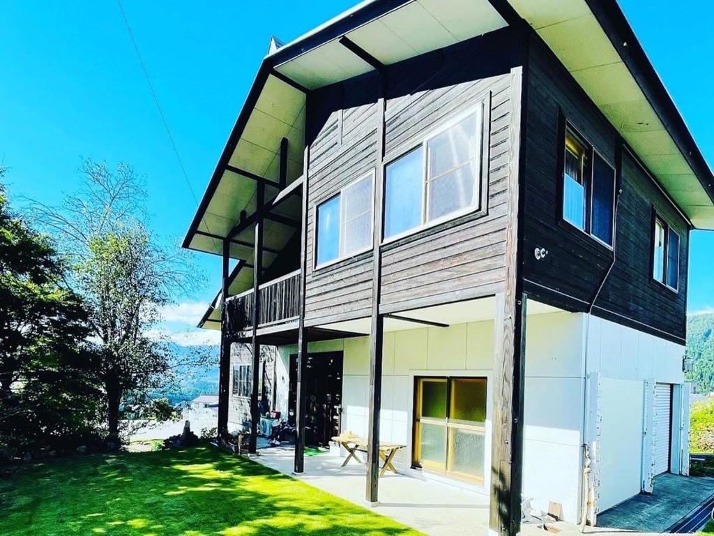 una casa con facciata in bianco e nero di Nakao Villa (ナカオヴィラ） a Nozawa Onsen
