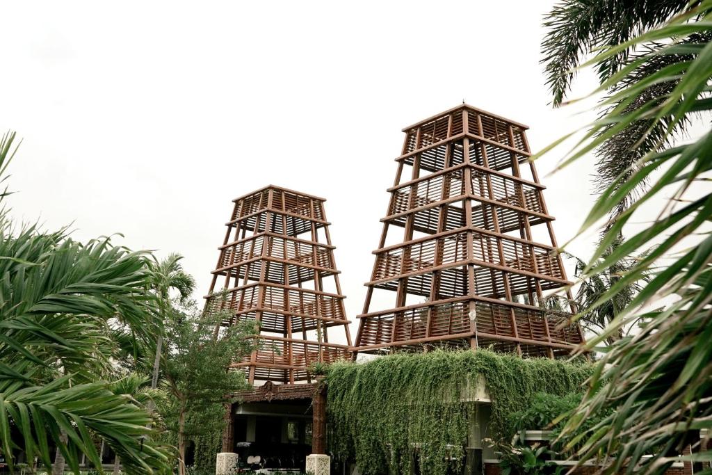 a building with three towers with grass at Sekuro Village Beach Resort in Jepara