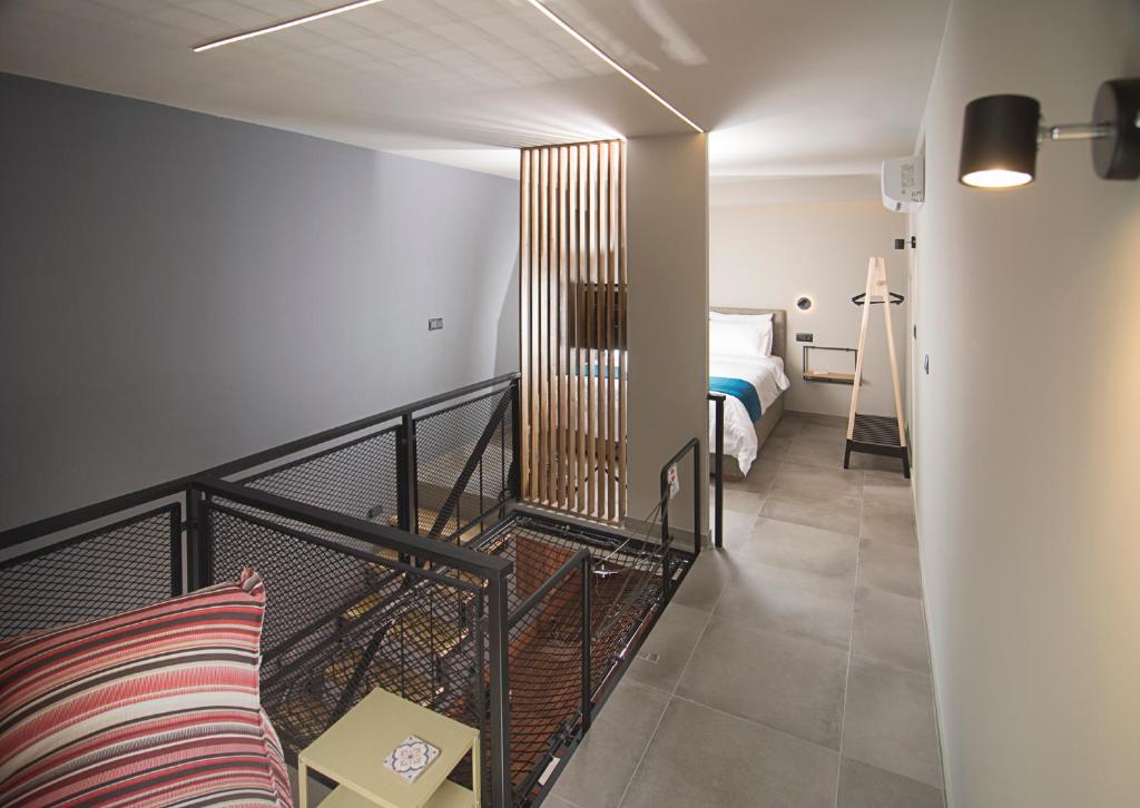 a living room with a bed and a couch in a room at Apertura Minima Living space next to sea in Kalamata