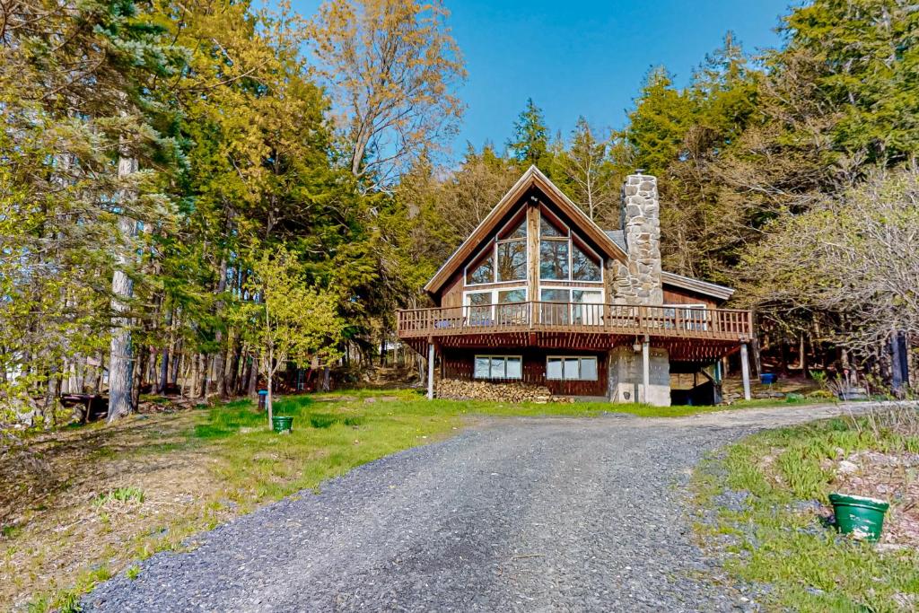 a house on a road in the woods at Mad River Valley Ski Chalet in Waitsfield