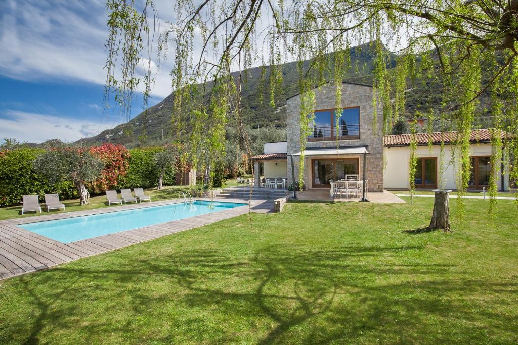 uma casa com piscina num quintal em Villa Cipressi - Luxuri Lounge - em Malcesine