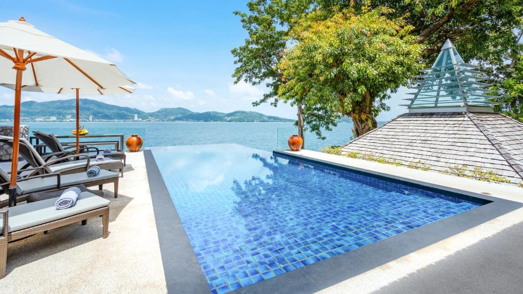 a swimming pool with a view of the water at Villa Rom Trai in Kathu