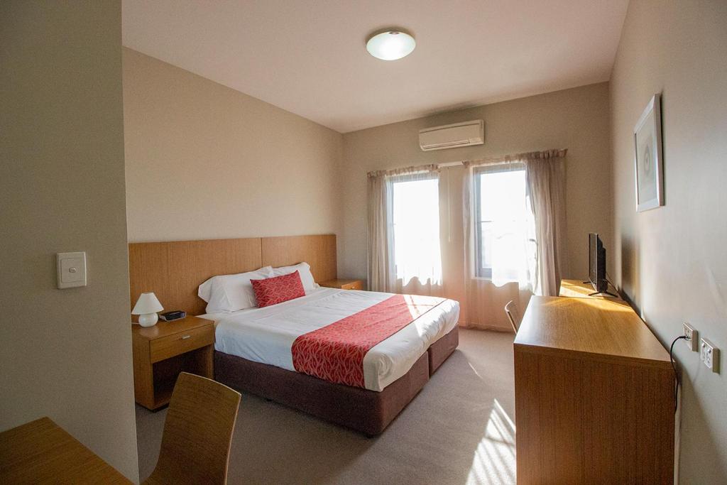 Postel nebo postele na pokoji v ubytování Gladstone Downtown Central Apartment Hotel Official