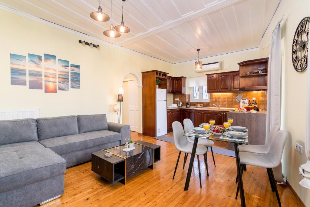a living room with a couch and a table with chairs at Tenedos old town in Corfu Town