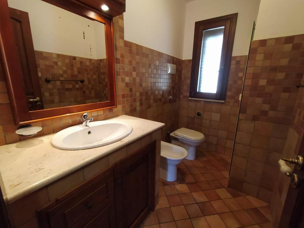 a bathroom with a sink and a toilet at SanVitoTour- Residence Il Baglio in San Vito lo Capo