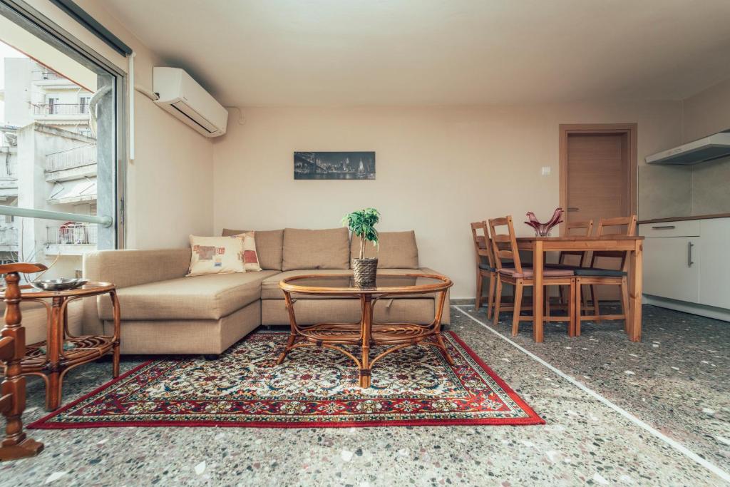 a living room with a couch and a table at Eptalofos Studio loft in Thessaloniki
