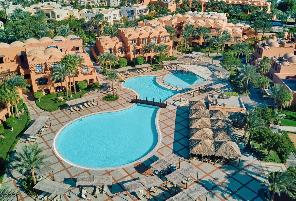 an aerial view of a resort with two pools at Jaz Makadi Oasis Resort in Hurghada