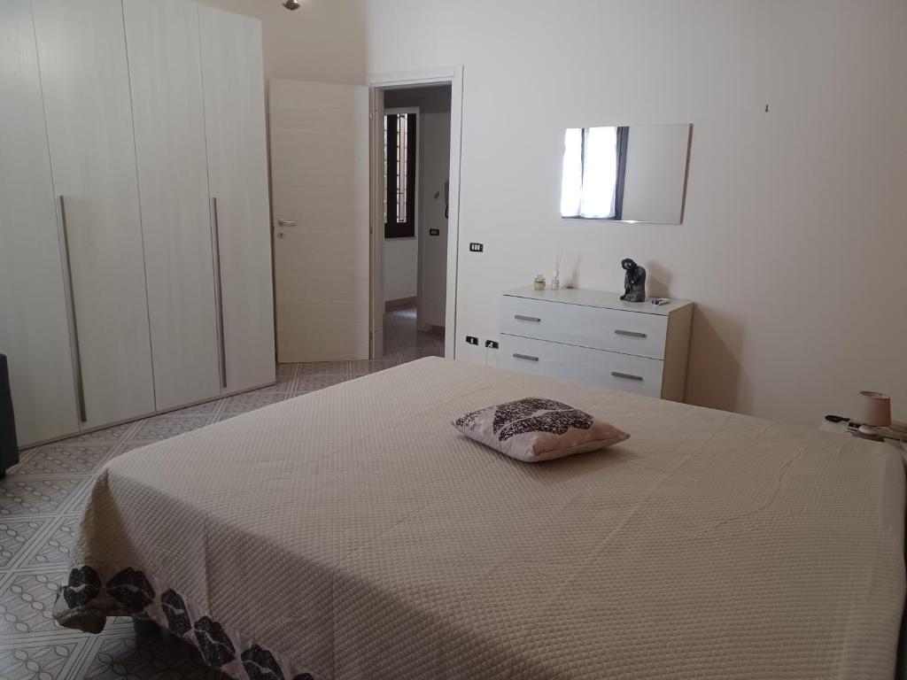 a bedroom with a bed with a pillow on it at Casa Grace in Mazara del Vallo