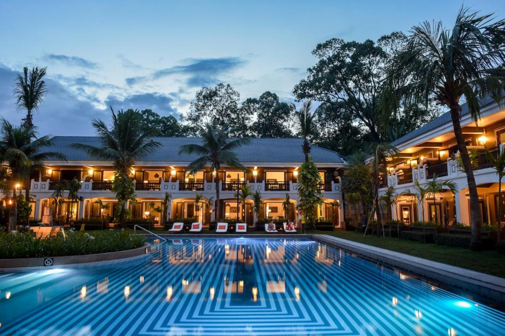 an exterior view of a resort with a large swimming pool at Shinta Mani Angkor & Bensley Collection Pool Villas in Siem Reap