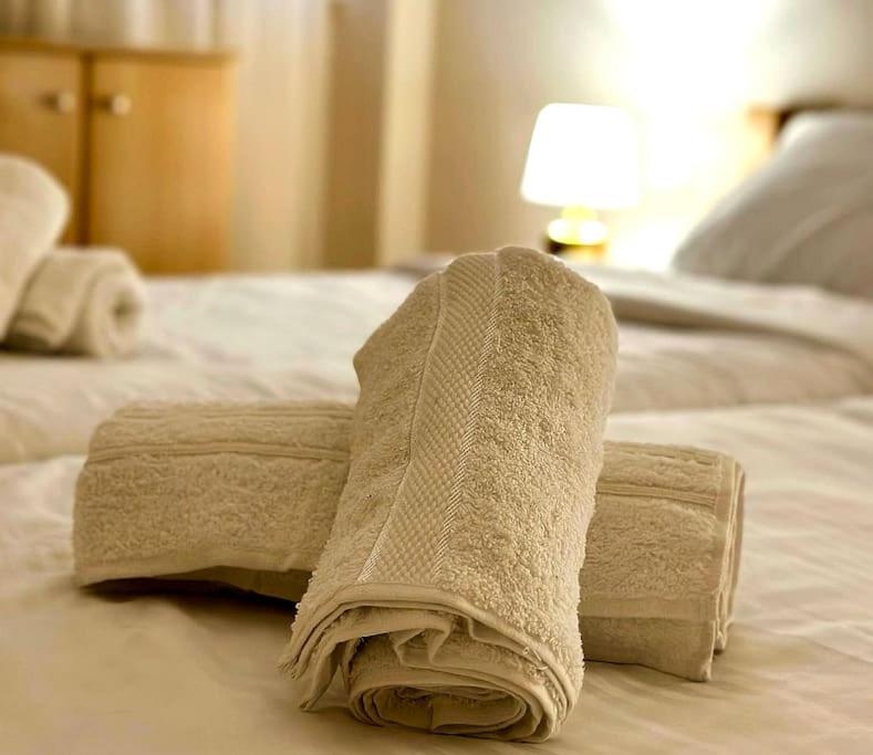 a towel sitting on top of a bed at Lakeside apartment in Struga
