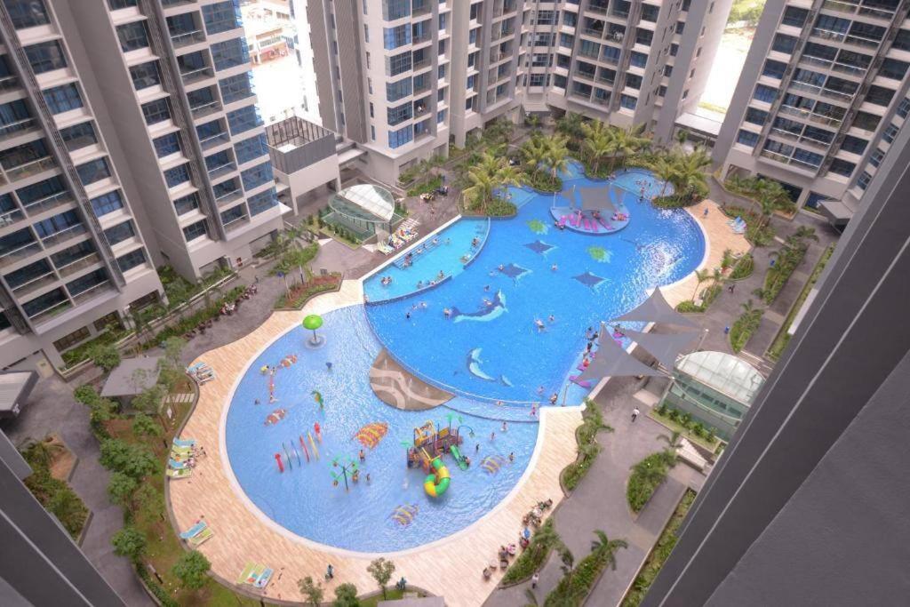 an aerial view of a water park in a city at Cozy Haven Atlantis with Large Swimming Pool in Melaka