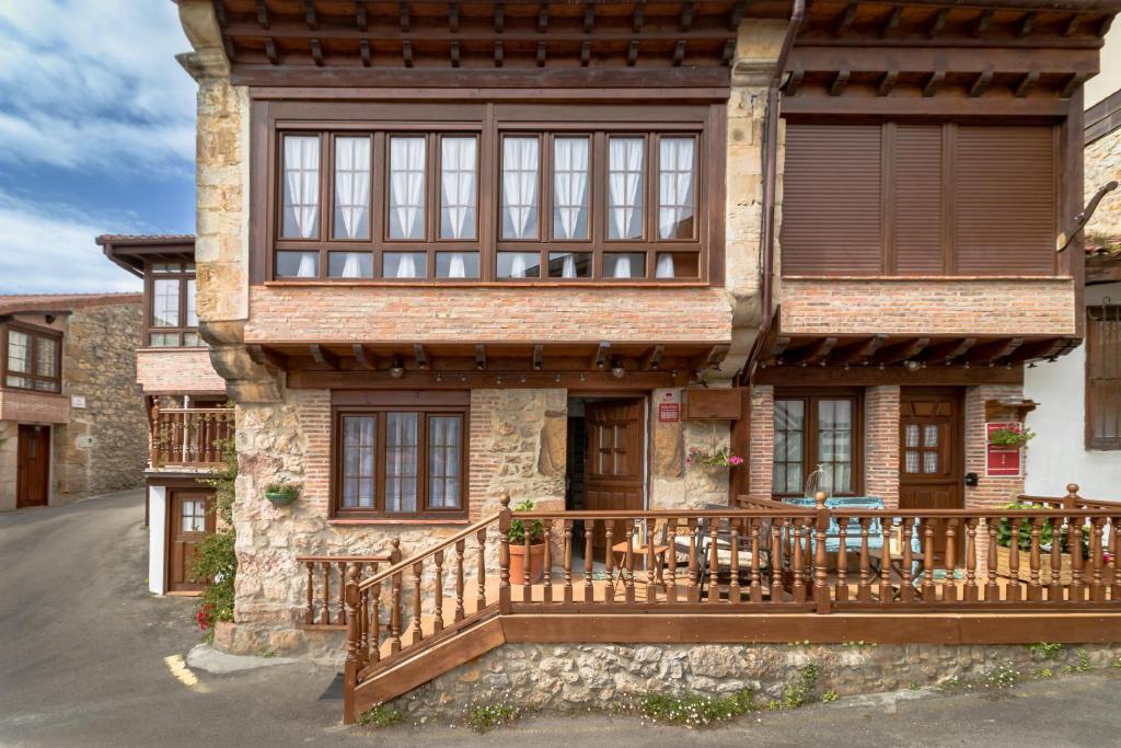 a house with a porch and a deck at CASA GERRA COMILLAS in Comillas
