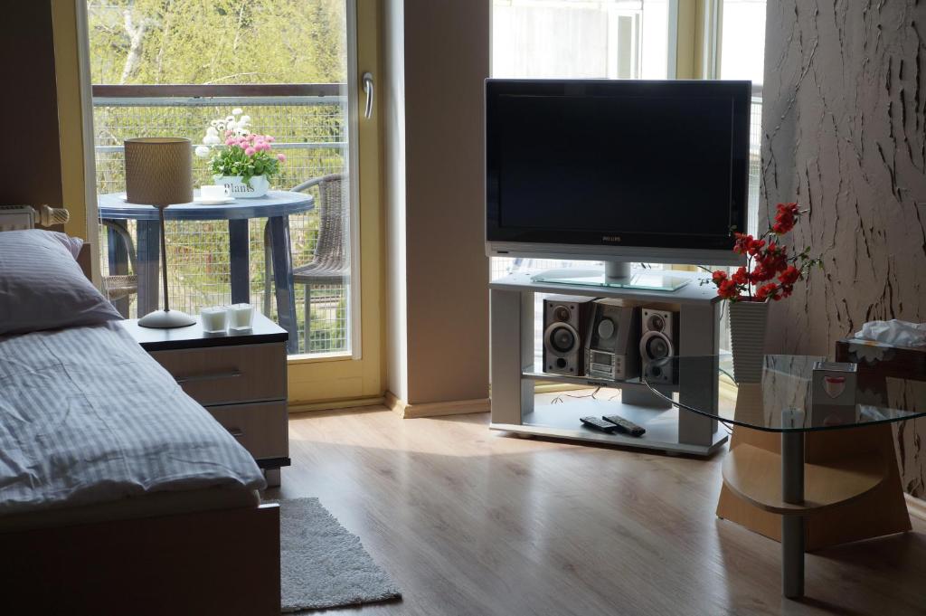 a living room with a flat screen tv on a table at Zacisze Leśne in Świnoujście