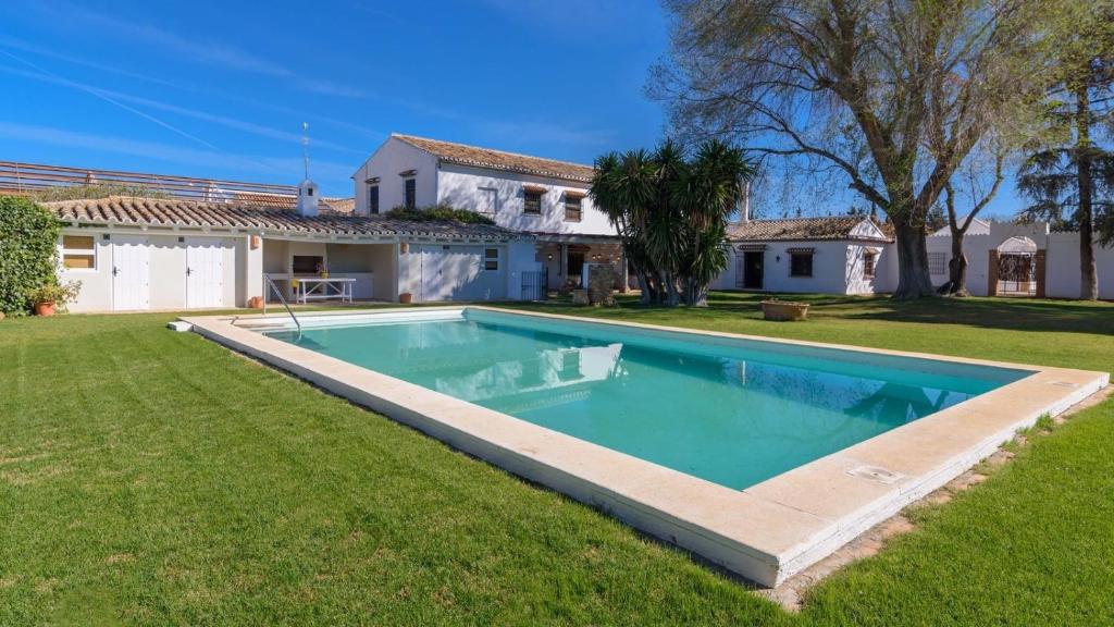 a swimming pool in the yard of a house at Cortijo del Río Antequera by Ruralidays in Antequera