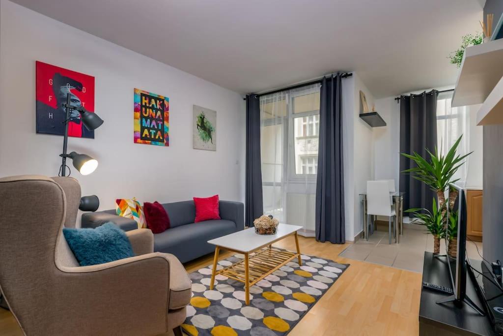 a living room with a couch and a table at APT Wit Free Secure Parking in Budapest