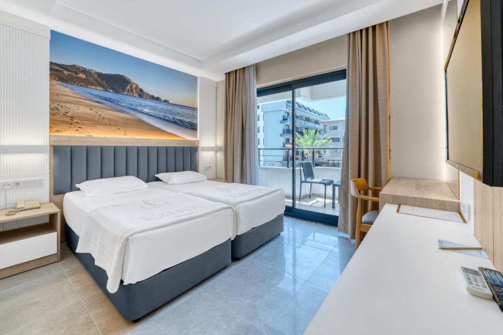 a hotel room with a bed and a balcony at Kahya Hotel in Alanya