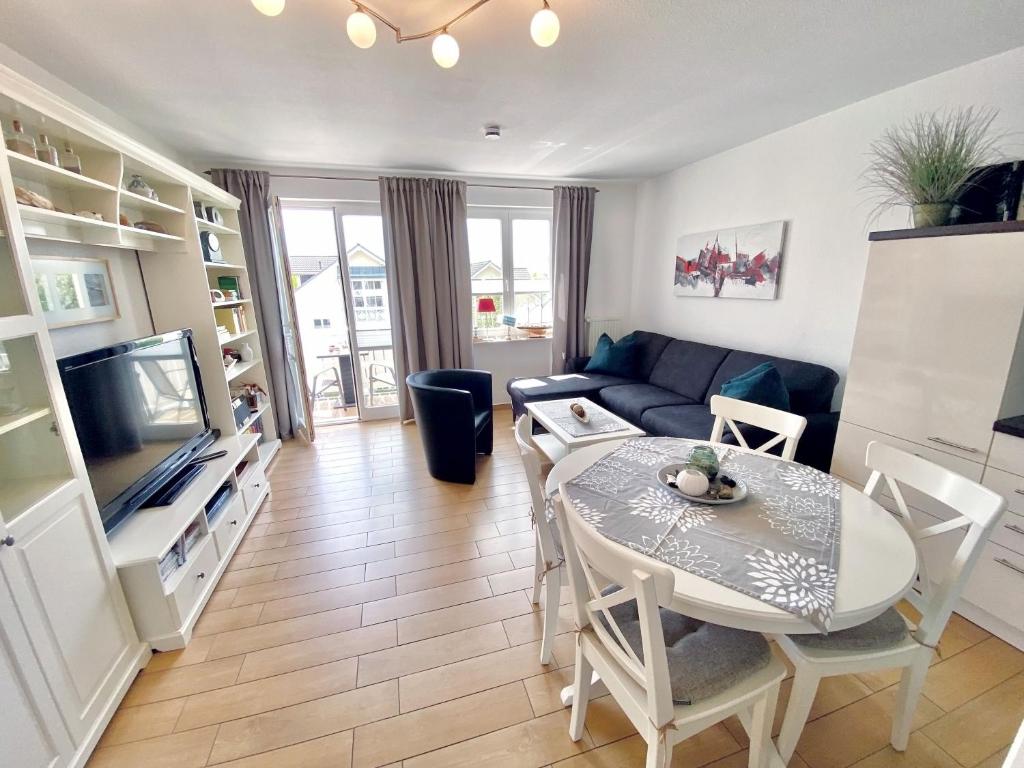 a living room with a table and a couch at Wohnpark Stadt Hamburg - Apt. 50 in Binz