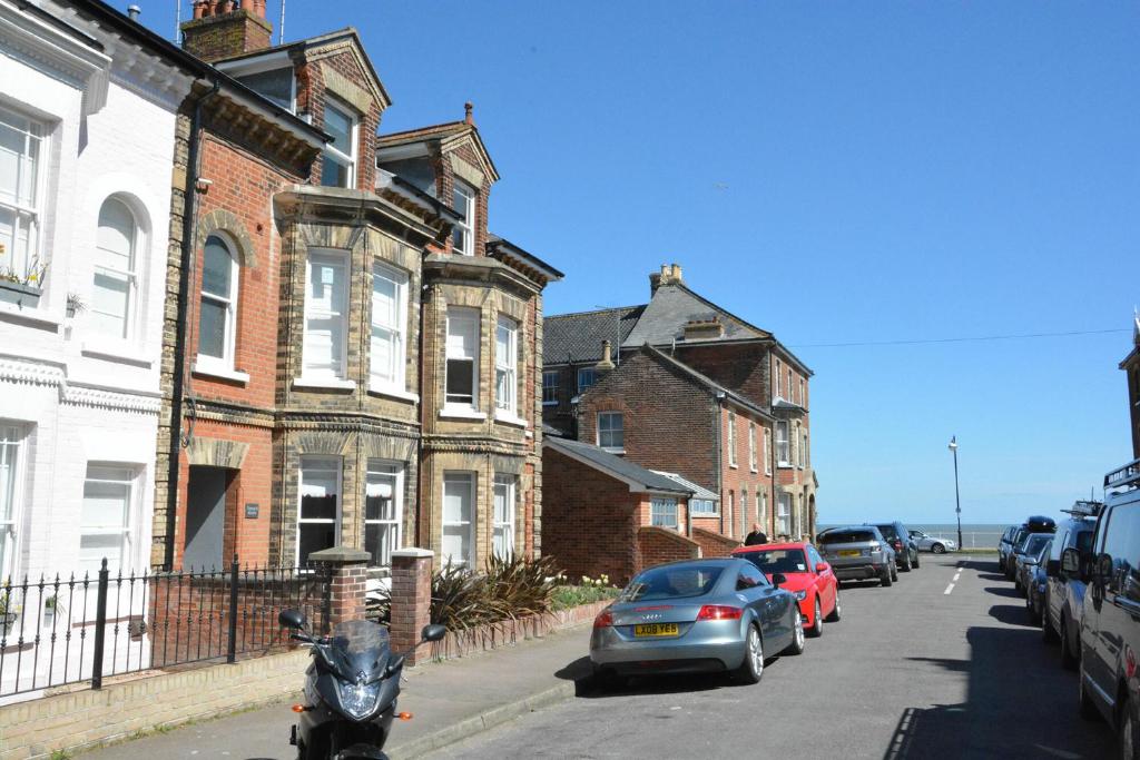 a motorcycle parked on a street in front of houses at Osprey in Southwold