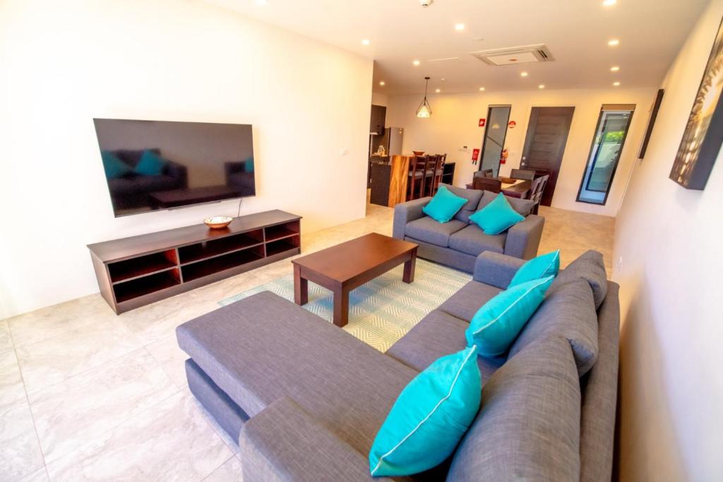 a living room with a couch and a tv at El Palm in Nadi