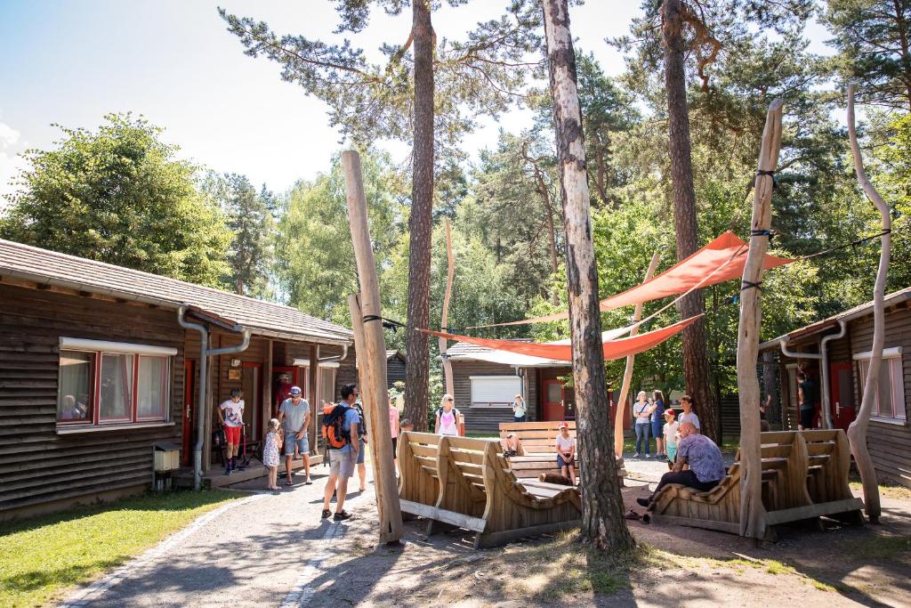 a group of people standing outside of a cabin at ZirkelsteinResort gGmbH in Schöna
