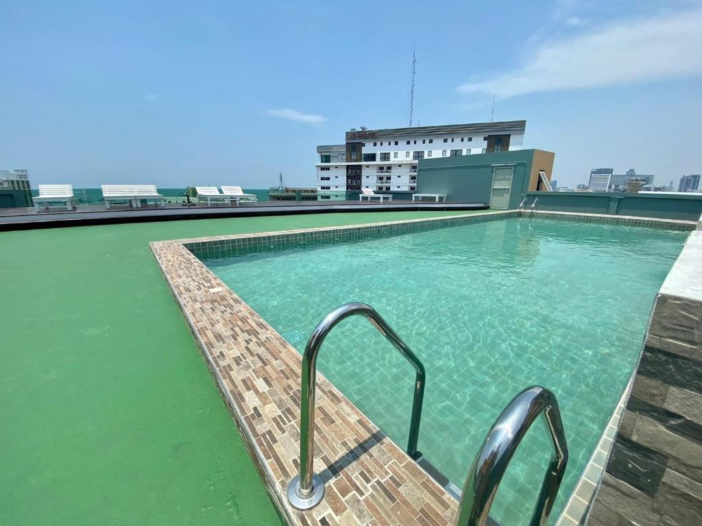 a swimming pool on the roof of a building at M CASA HOTEL PATTAYA in Nong Prue