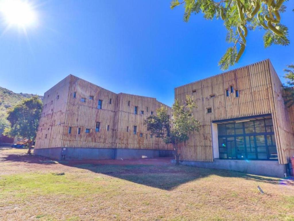 a large wooden building with a large window at Thuto Centre Conferencing & Bush Lodge in Bela-Bela