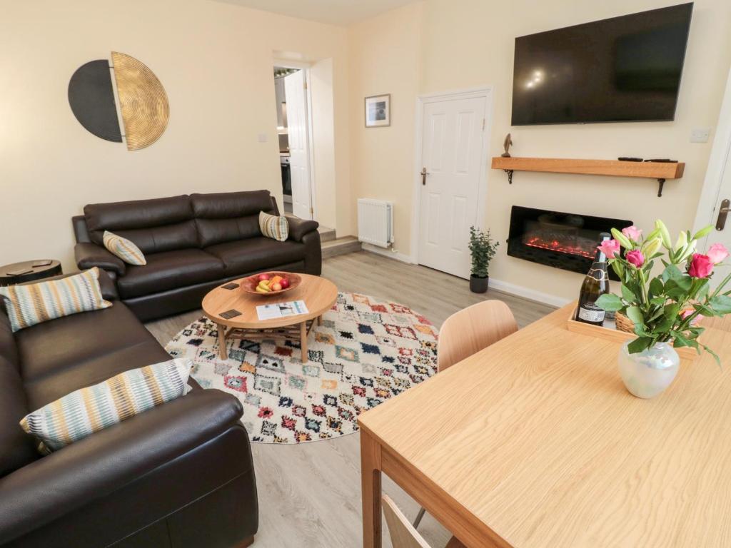 a living room with a couch and a table at Stone's Throw in Morpeth