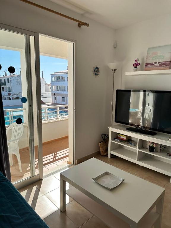 a living room with a tv and a table at Apartamentos Calan Blanes Park CB APM 2142 ,nº207 in Cala en Blanes