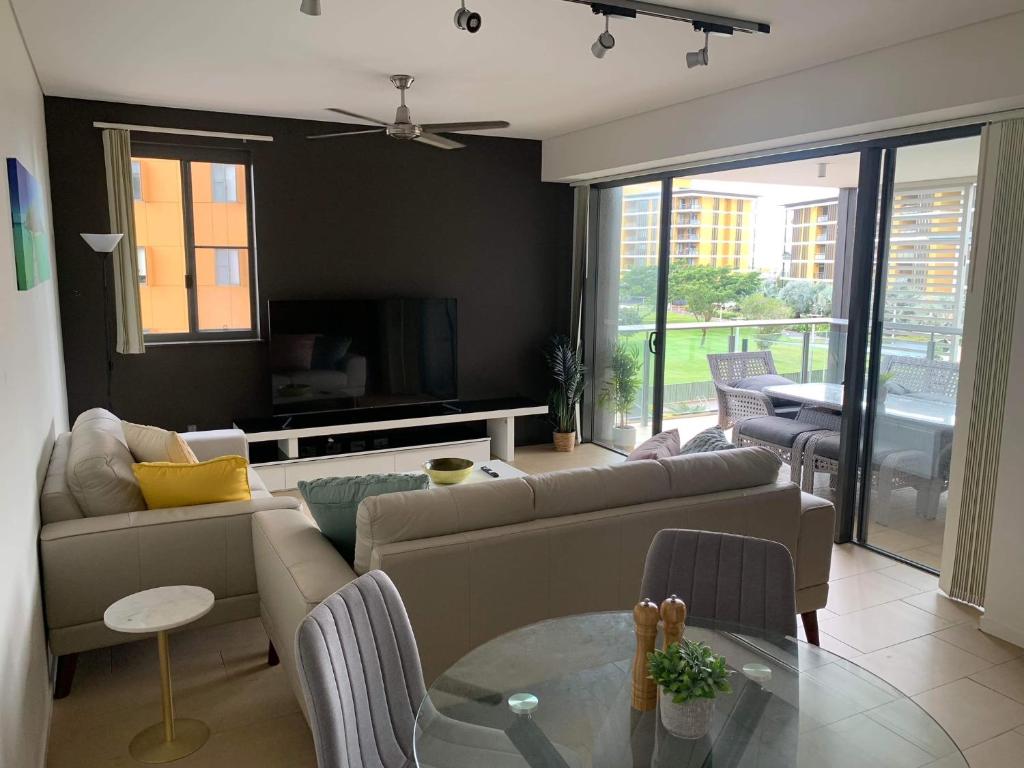 a living room with a couch and a table at Darwin Waterfront Luxury Condo in Darwin