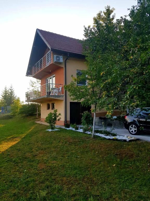 a house with a car parked in front of it at Vila Haris in Sarajevo