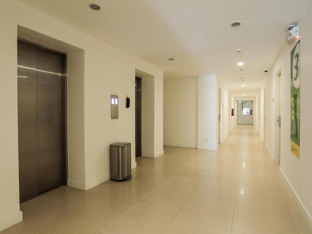 an empty hallway with a trash can in a building at Go Hotels Manila Airport Road in Manila