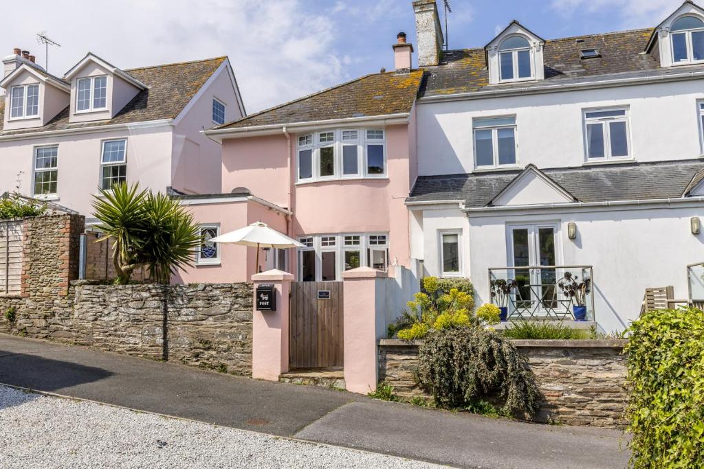 a house with a pink and white facade at The Pink House in Dartmouth